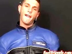 Young biker with tatts and piercings plays with his feet