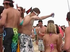 Amateur cuties wearing bikinis get caught on a voyeur's cam on a beach